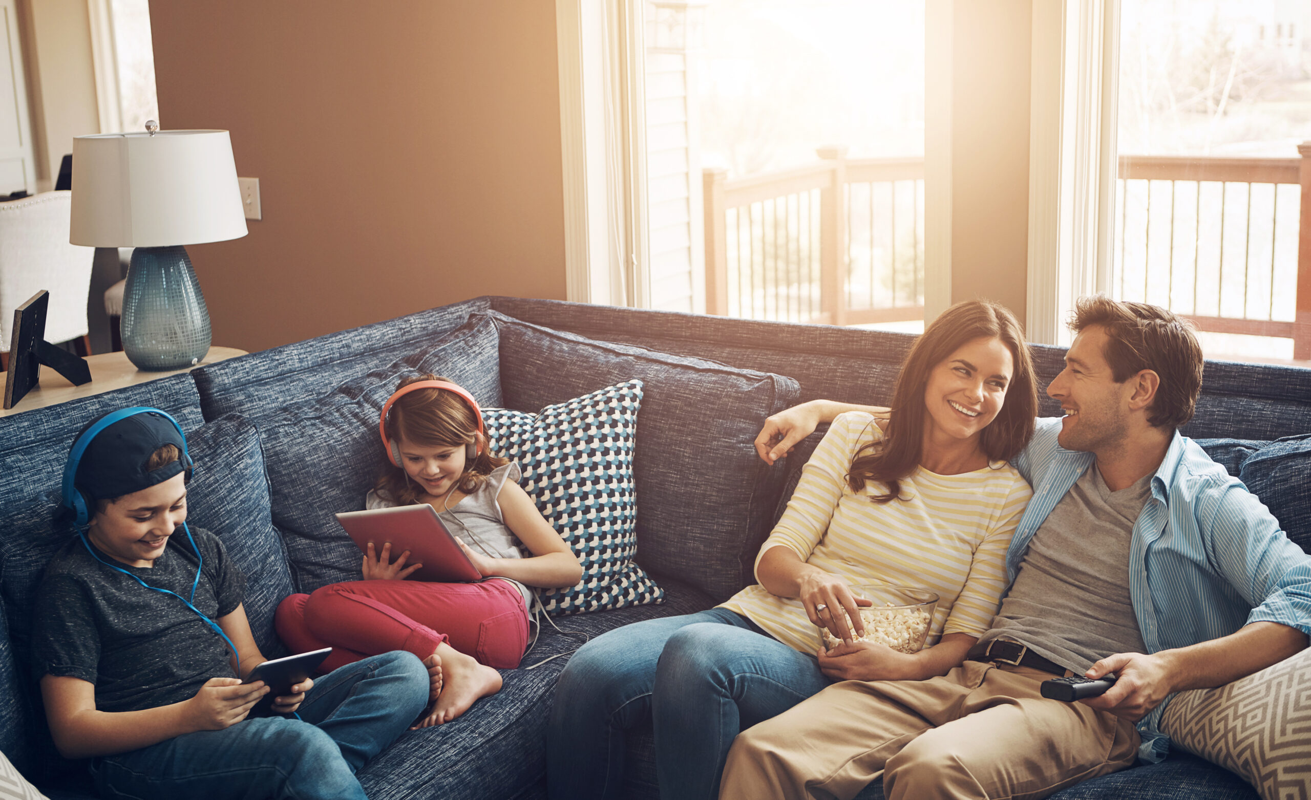 Happy family relaxing together on a couch at home"