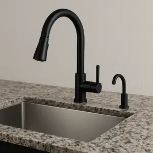 Modern kitchen sink with black faucet and granite countertop.