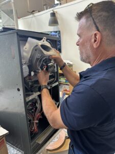 Home inspector examining a furnace during property evaluation.