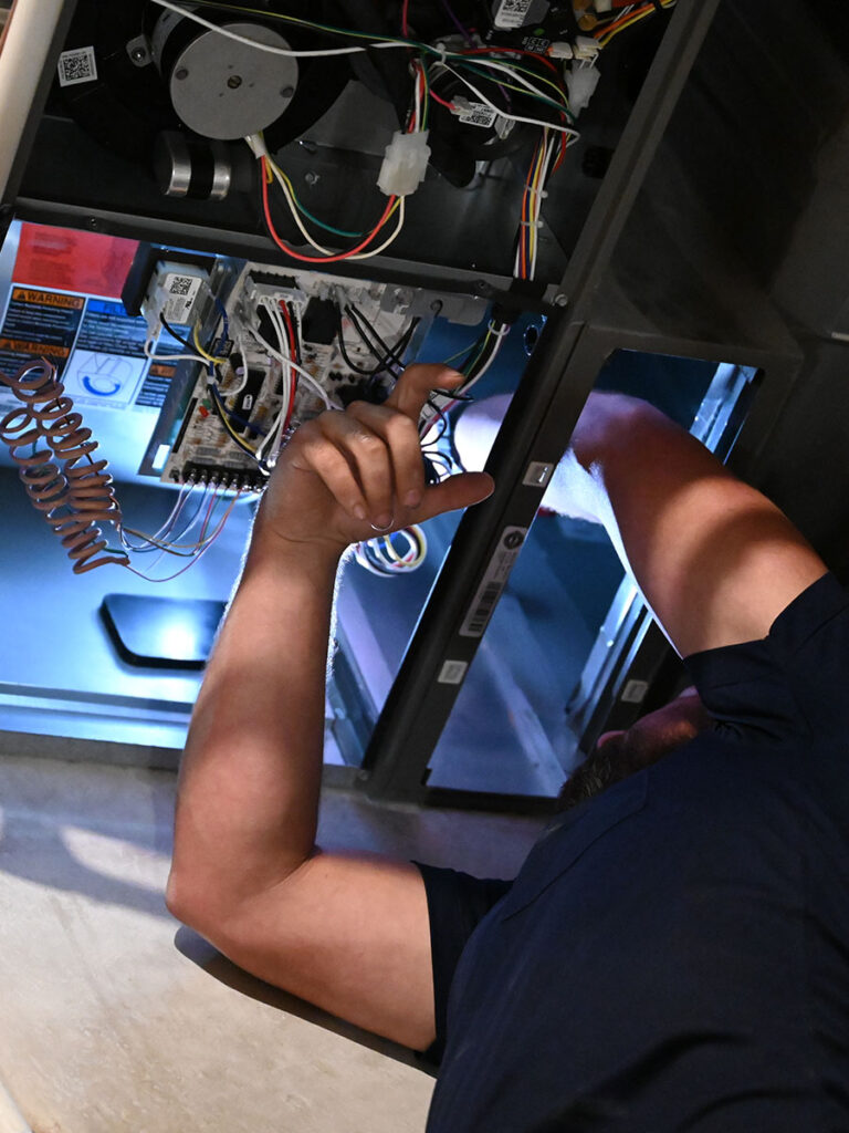 HVAC technician inspecting home air system