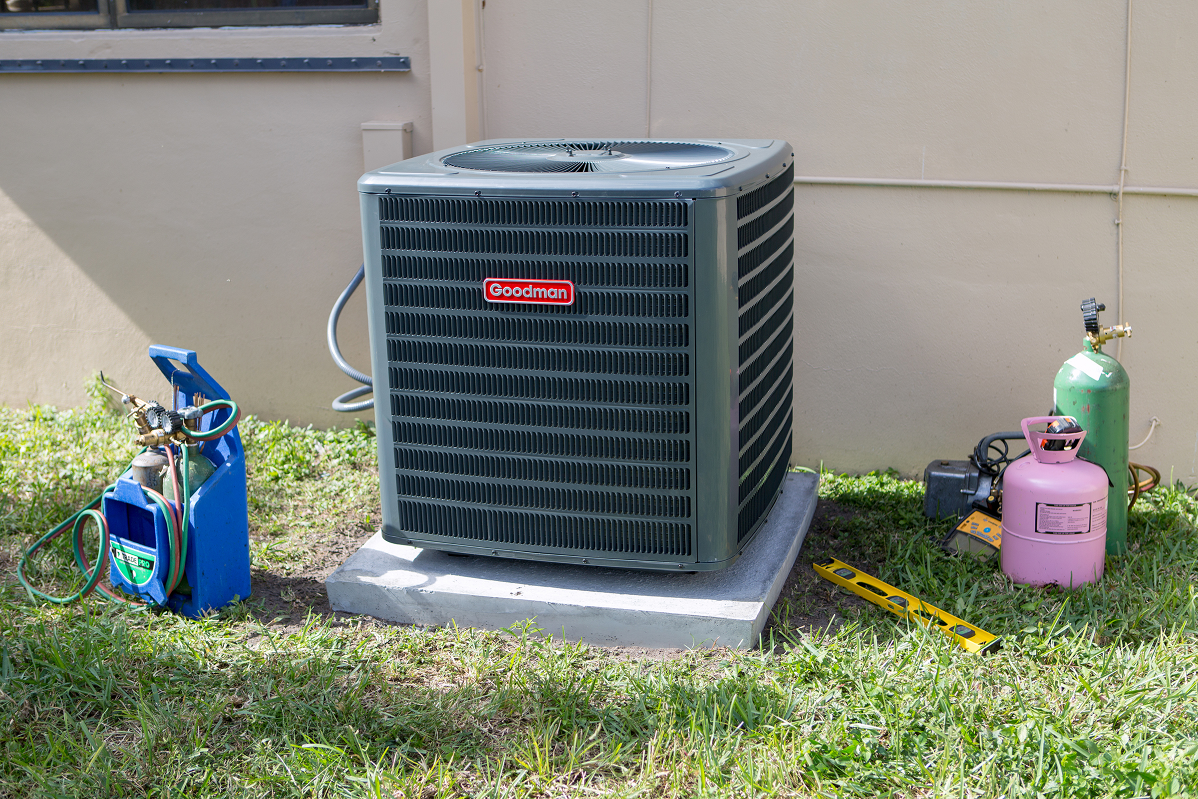 HVAC professional installing outdoor condenser unit