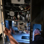 Technician installing a 4-inch HVAC filter in a Utah home